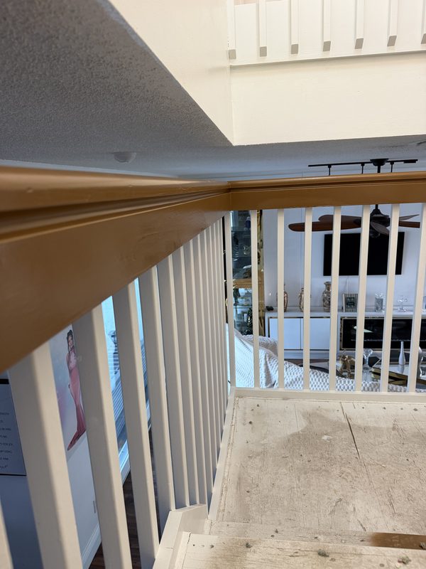 Close up of a refinished handrail showing a smooth even sheen