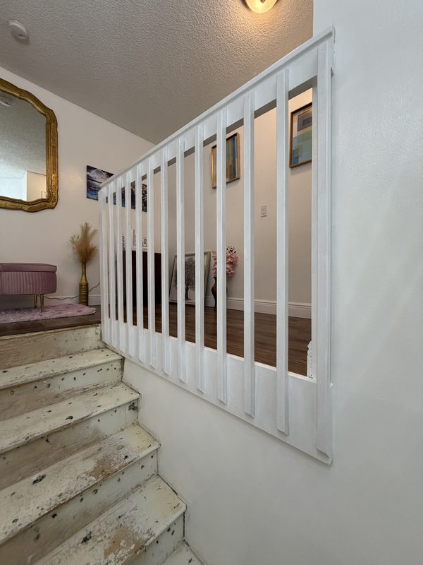 White painted stair railing and balusters after refinishing