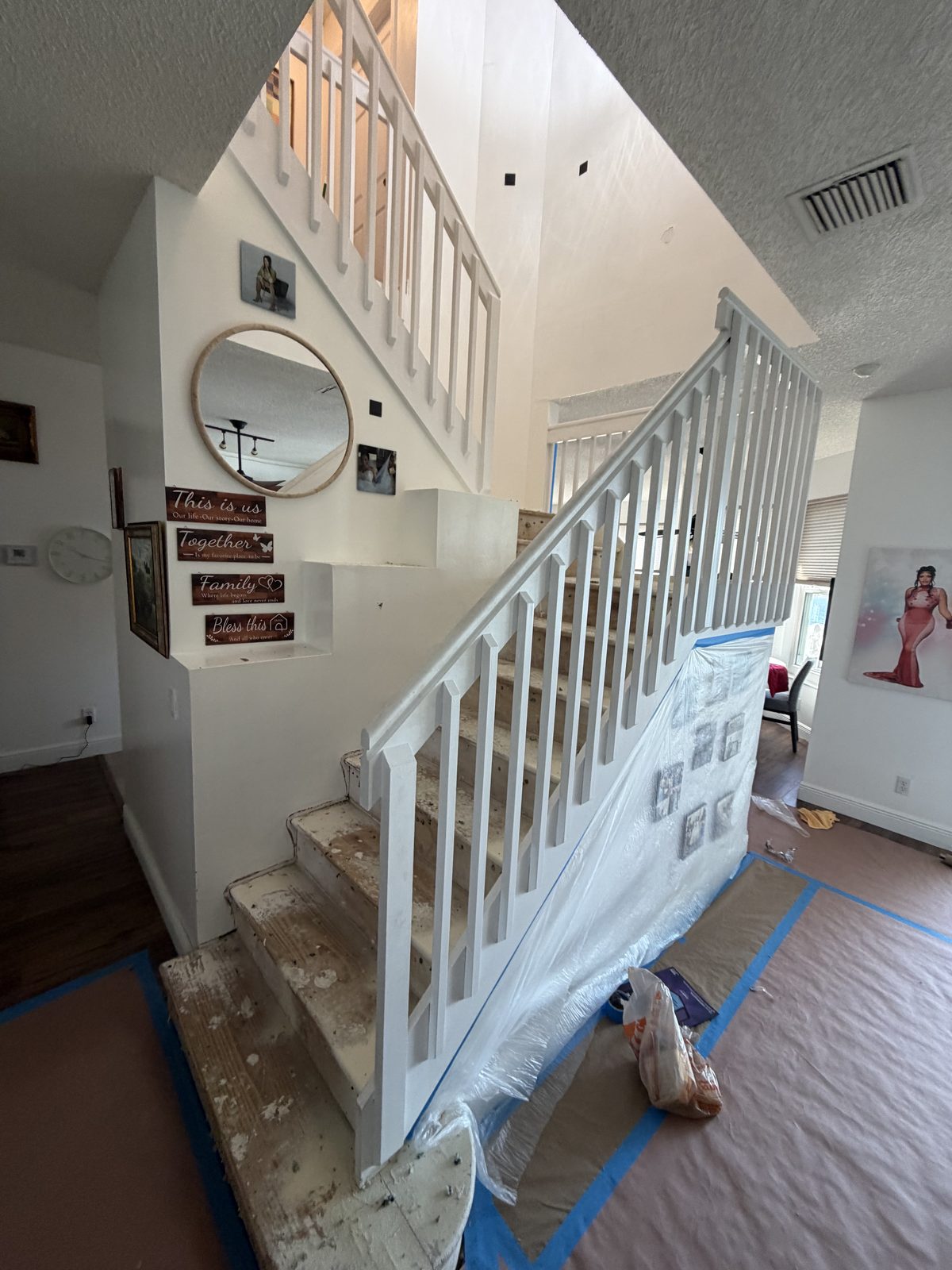 Staircase fully masked and protected with plastic sheeting and drop cloths before painting