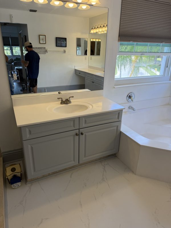 Bathroom vanity refinished by GR Painting in soft grey with a sprayed cabinet enamel